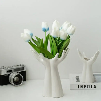 Decorbites™ hand-painted white ceramic vase shaped like two hands cradling white tulips with blue-tipped petals arm palm