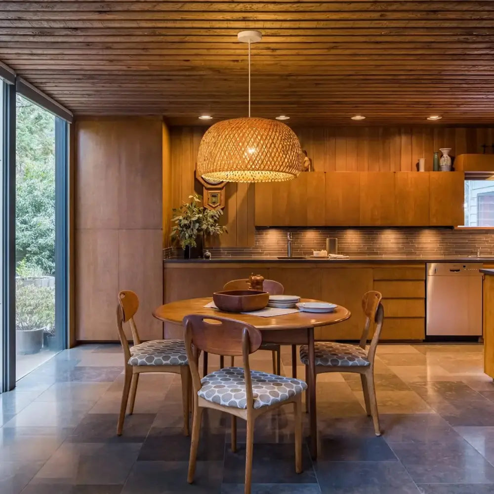 Warm-toned hand-woven bamboo lantern pendant light by decorbites hangs above wooden dining table