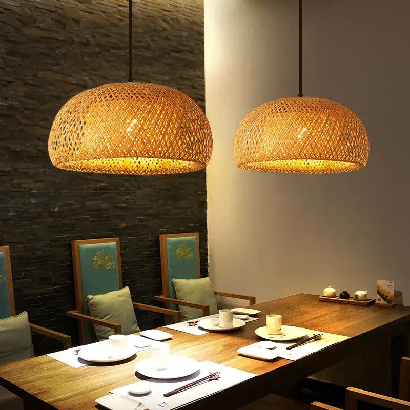 Warm-toned handcrafted DecorBites™ bamboo pendant lamps with dome shape hanging above dining table