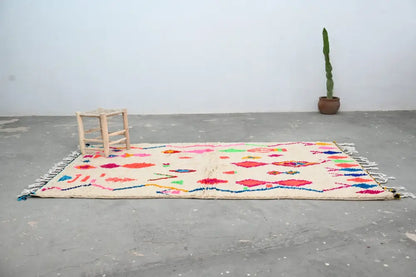 DecorBites™ handcrafted moroccan azilal rug in cream with vibrant geometric patterns and colorful fringe 246 x 146 cm