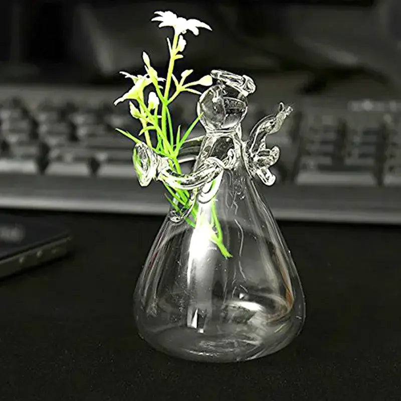 DecorBites™ handmade clear glass angel vase with delicate wings and halo holding small white flowers for home decor