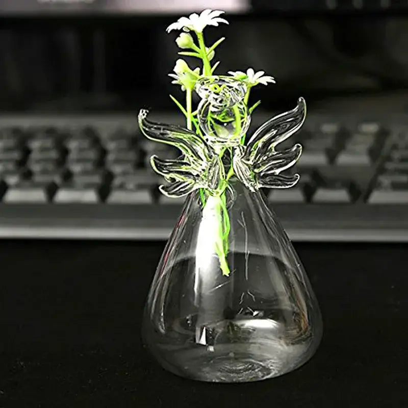 DecorBites handmade clear glass angel vase with delicate wings and floral design holding small white daisies