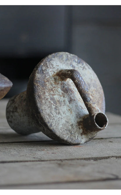 Rusty weathered metal funnel with circular top and narrow spout shown as back side of decorbites™ ceramic vase for dried flowers