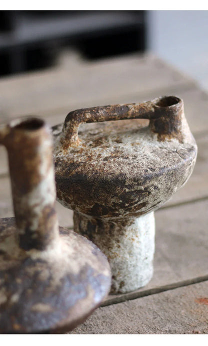 Rust-stained handmade ceramic vase with handle and two openings featuring aged patina for dried flowers decor