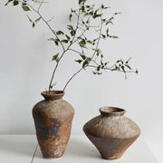 Two rustic brown handmade ceramic vases with earthy textured surfaces for zen flower arrangements by decorbites