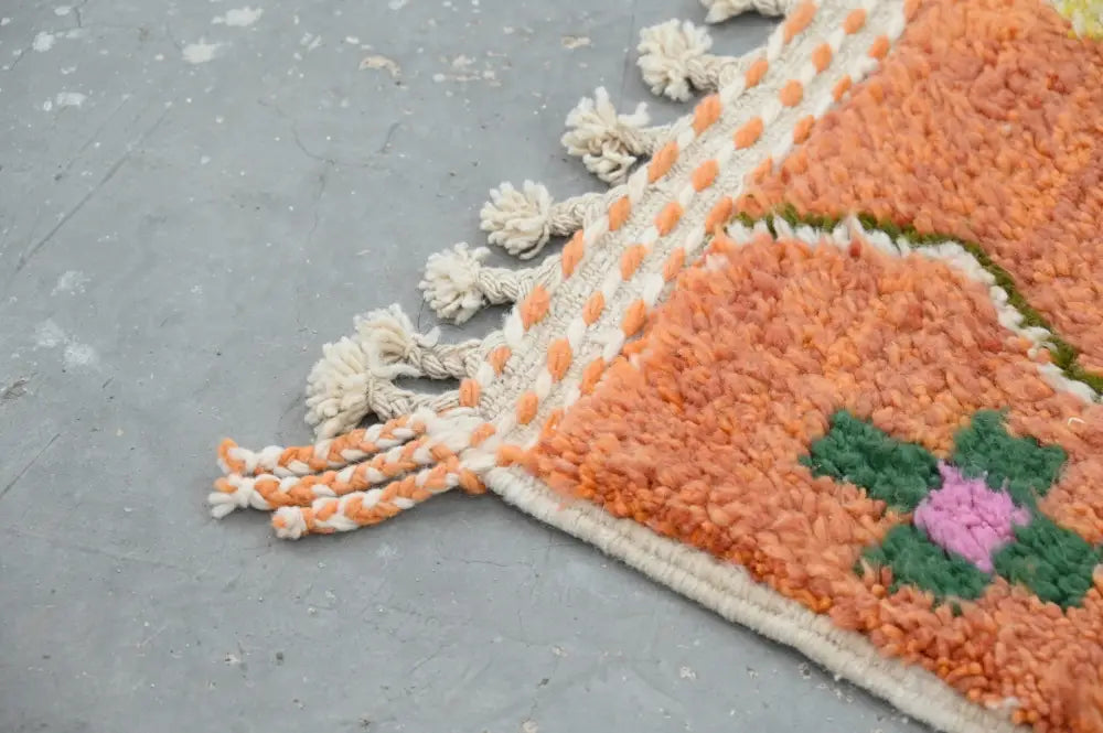 Orange moroccan azilal carpet with plush texture green and pink floral motif cream tassels handmade traditional azilal