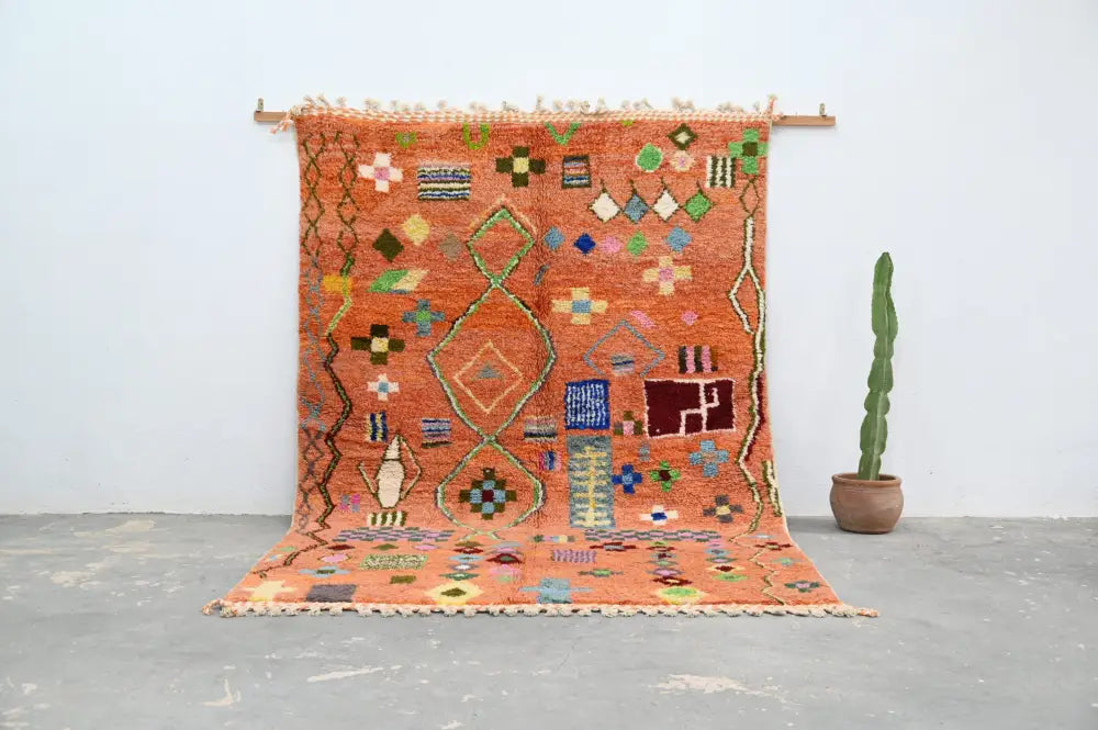 Vibrant orange decorbites handmade traditional azilal carpet with intricate geometric floral patterns and fringed border 305x205 cm