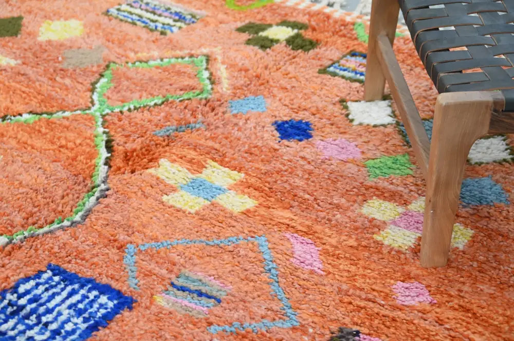 DecorBites™ handmade traditional azilal carpet with vibrant orange base and colorful geometric patterns 305x205 cm