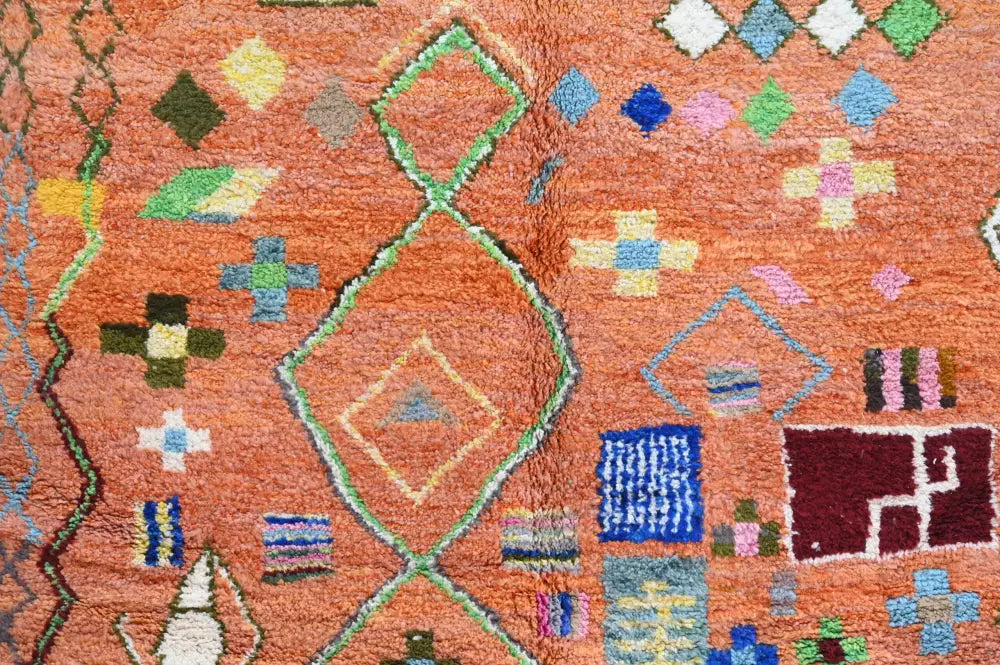 A vibrant orange DecorBites™ handmade traditional azilal carpet with geometric green blue pink and yellow patterns 305x205 cm
