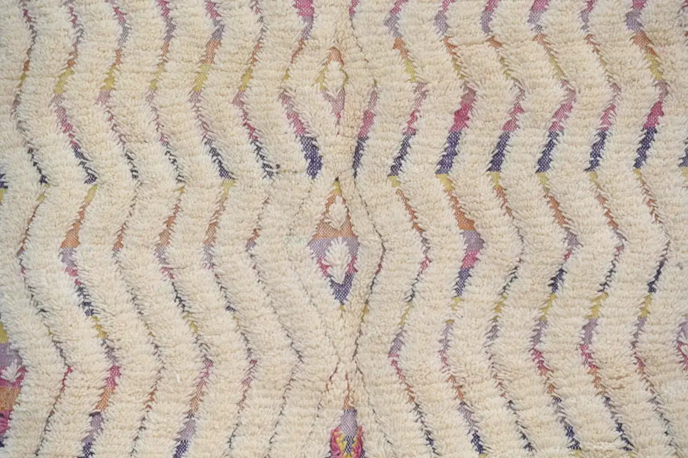 Cream-colored handmade moroccan azilal rug with textured zigzag pattern in pastel pink purple and yellow tones 223x133 cm