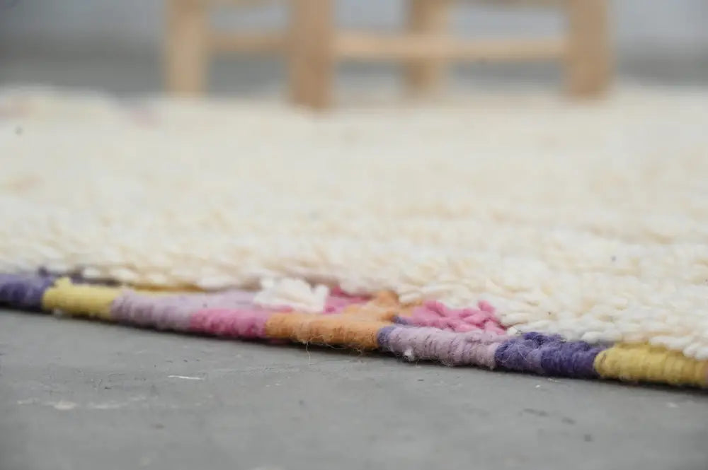 Decorbites™ handmade moroccan azilal rug 223x133 cm with soft cream wool and colorful woven striped border
