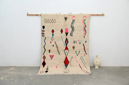 Beige moroccan handmade azilal rug in natural wool with colorful pink red blue and brown geometric patterns 223x157cm