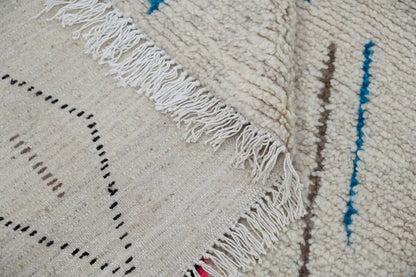 Cream-colored decorbites™ handmade moroccan azilal rug with blue brown black geometric patterns in natural wool 223x157cm