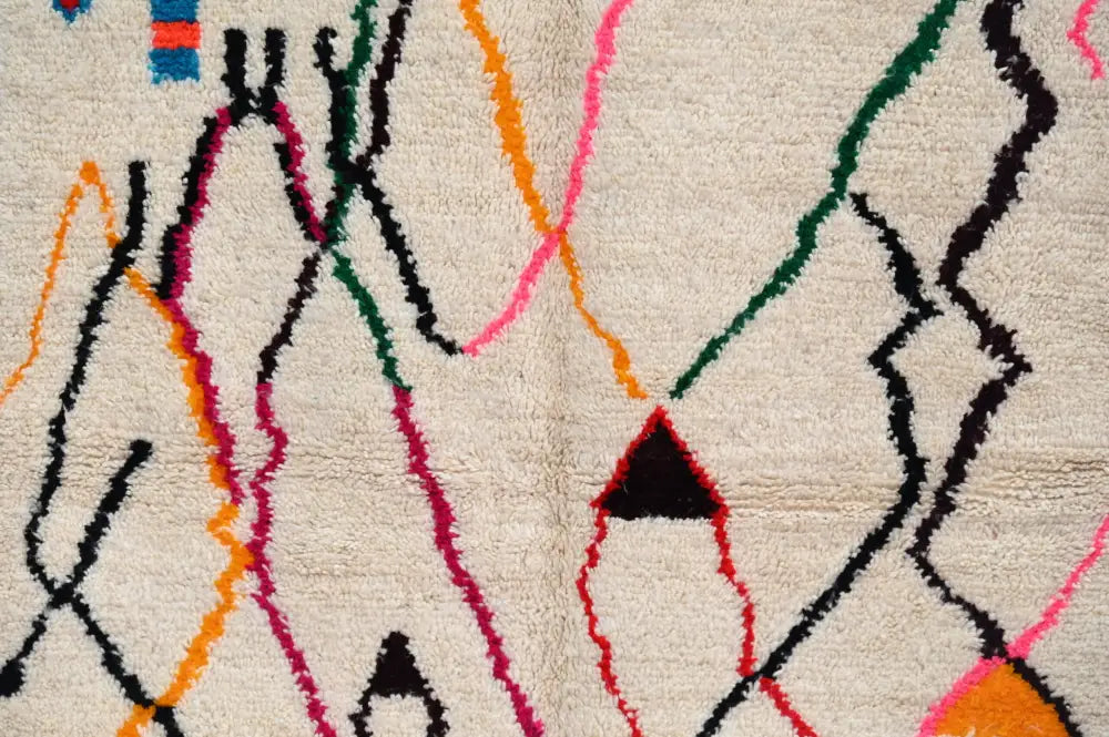 Beige decorbites handmade moroccan azilal rug with vibrant geometric patterns showcasing moroccan craftsmanship