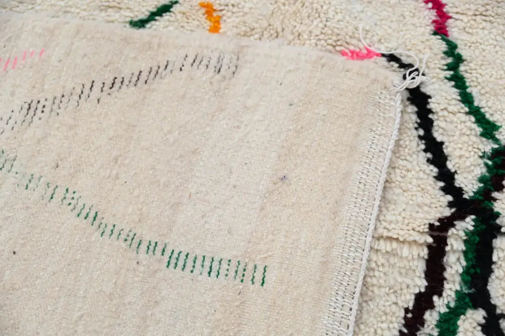 Beige wool decorbites™ handmade moroccan azilal rug with hand-knotted green and black geometric patterns