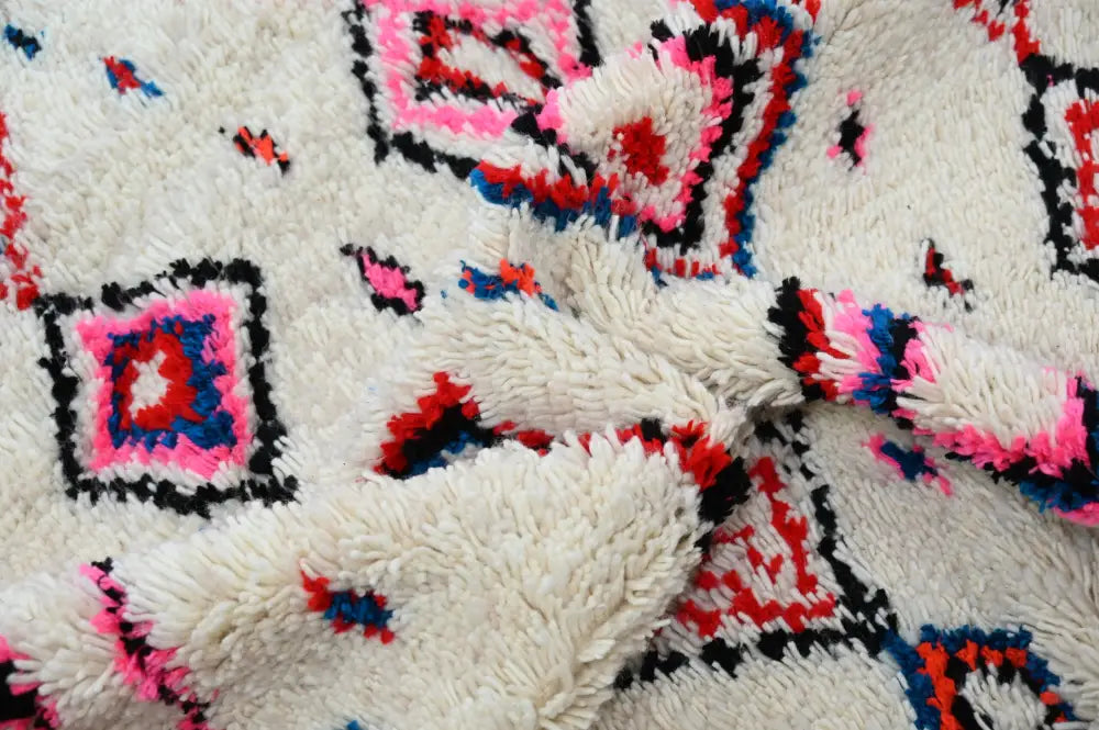 Cream-colored plush wool handmade traditional azilal rug with bold pink red and black geometric patterns 230x154cm