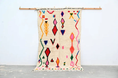 Beige moroccan handmade azilal rug with vibrant geometric patterns in natural wool by DecorBites 231x131cm