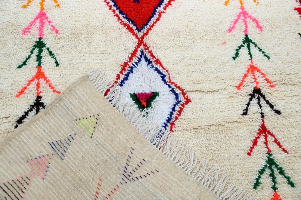 Beige decorbites™ handmade moroccan azilal rug with vibrant red blue green pink and black geometric patterns 231x152 cm