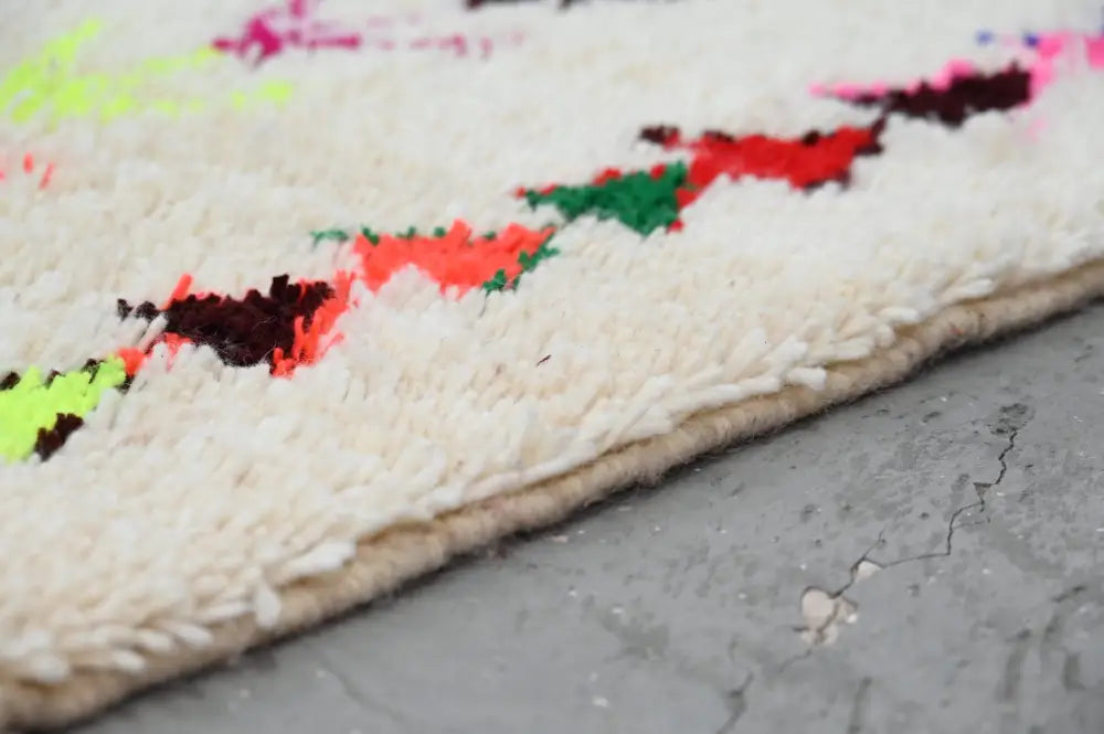 A plush white decorbites™ handmade moroccan azilal rug with neon pink red green and black geometric patterns 231x152 cm