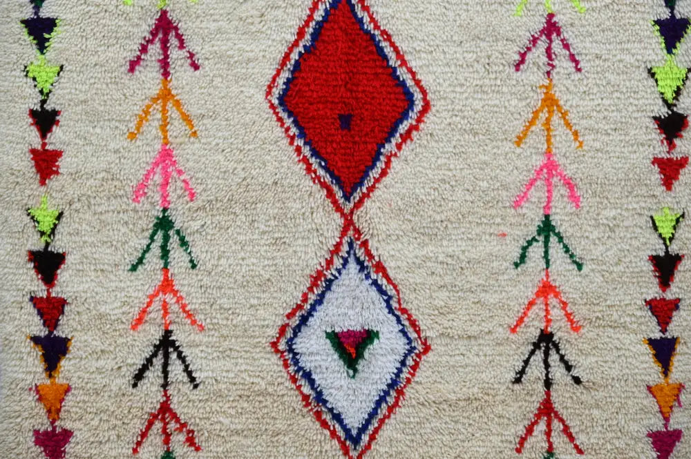 DecorBites™ handmade moroccan azilal rug with vibrant red and white diamonds and colorful geometric motifs on cream base
