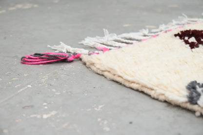 Cream-colored natural wool azilal rug with fringed edges and vibrant pink and dark gray tassel accents 234x161 cm