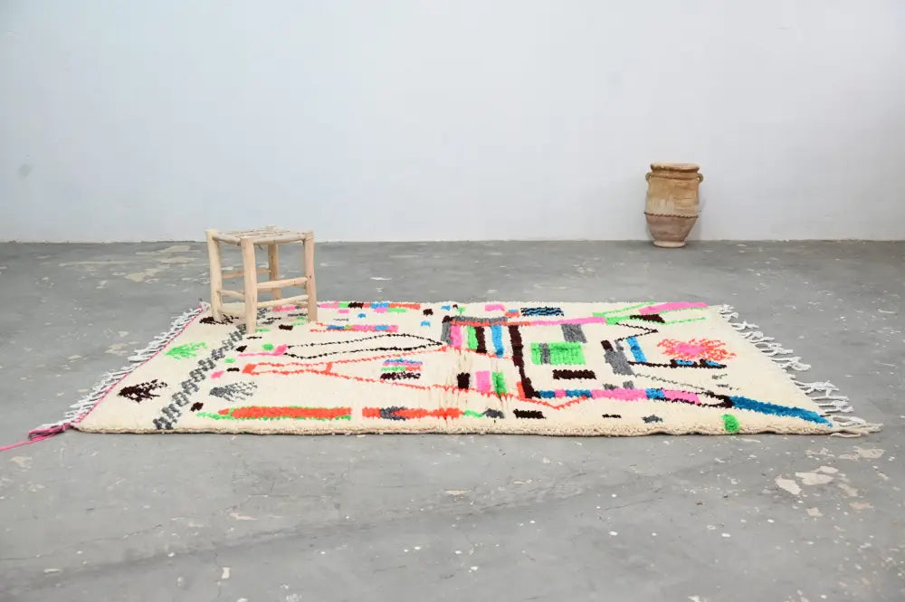 DecorBites™ handmade Moroccan azilal rug in cream with vibrant colors and bold geometric patterns in natural wool