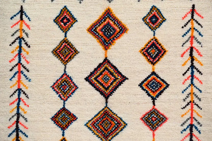 Beige handmade moroccan azilal rug with intricate geometric patterns in vibrant orange red blue and black 236x155cm