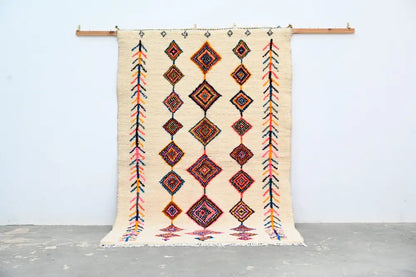 Beige woven decorbites handmade moroccan azilal rug 236x155cm with geometric diamond and arrow patterns in orange red pink and black