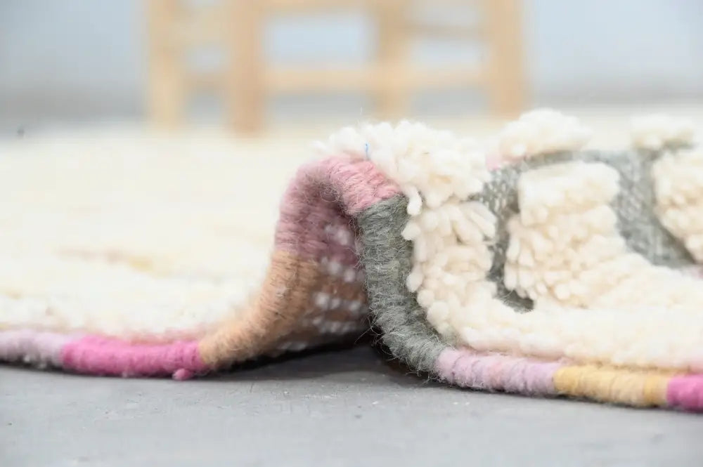 Decorbites handmade moroccan azilal rug cream wool with fluffy texture and colorful pink gray yellow striped border