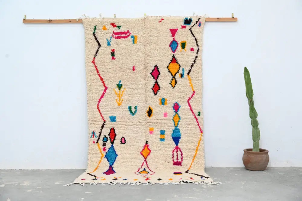 Beige handmade DecorBites™ azilal rug 240x132cm with colorful pink blue yellow and red geometric patterns