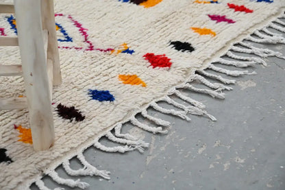 Cream-colored decorbites™ handmade azilal rug 240x132cm with colorful geometric patterns and white fringe
