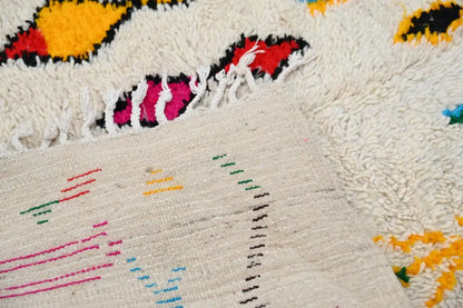 Cream-colored decorbites™ handmade moroccan azilal rug 240x132cm with vibrant hand-knotted geometric patterns