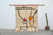Beige woven decorbites™ handmade moroccan azilal rug with bold black orange pink geometric patterns and fringed edges