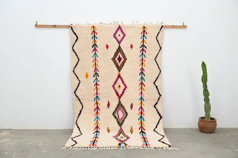 Beige handmade moroccan azilal rug with colorful geometric patterns and fringed edges by DecorBites™ 242x150cm