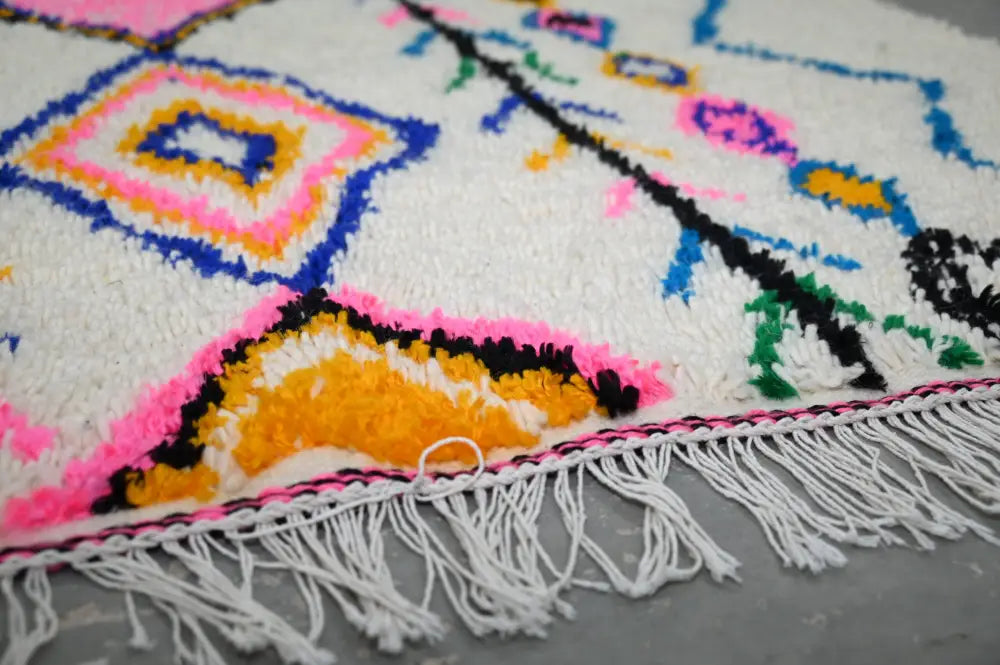 DecorBites™ handmade moroccan azilal rug 243x131 cm with white base and vibrant geometric patterns in multiple colors