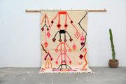 Beige handmade moroccan azilal rug with vibrant pink orange black and red geometric patterns 245x141cm decorbites™