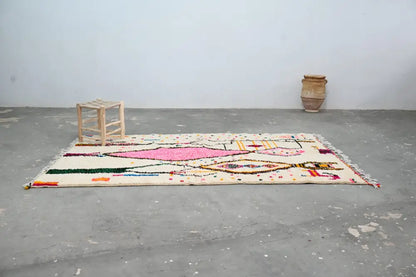 Beige moroccan azilal rug with vibrant pink green yellow and orange geometric patterns handmade by decorbites