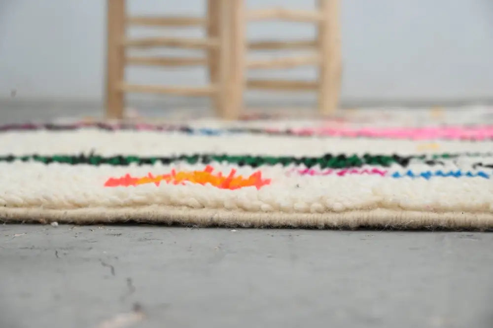 DecorBites™ handmade moroccan azilal rug 245x146 cm with cream base and vibrant horizontal stripes in pink green black orange and blue