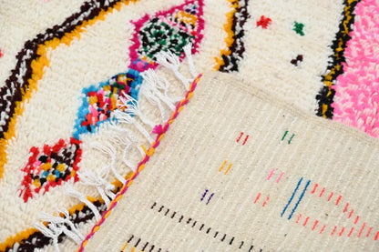 DecorBites™ handmade moroccan azilal rug with cream base and vibrant geometric pink blue yellow green and black patterns