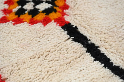 Cream-colored handmade moroccan azilal rug with bold black red and orange geometric pattern 246x146 cm