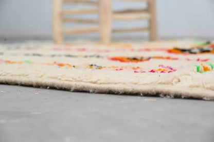 Cream-colored handmade moroccan azilal rug with vibrant multicolored geometric patterns and fringed edge 246x146 cm
