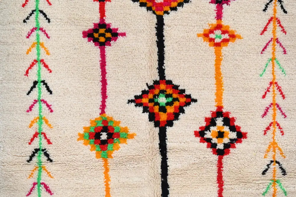 Decorbites™ handmade moroccan azilal rug with vibrant geometric patterns on a cream base in red orange green black and pink