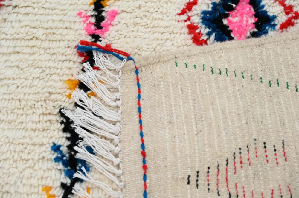 Beige decorbites™ moroccan handmade azilal rug with colorful fringe and embroidered geometric patterns in natural wool