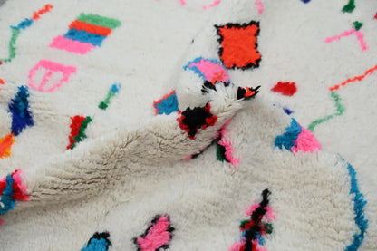 Decorbites™ handmade moroccan azilal rug with fluffy white texture and vibrant pink blue green red geometric patterns 247x141 cm