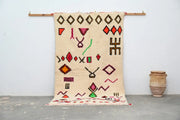Beige handmade moroccan azilal rug with geometric patterns in red orange green and brown 247x146 cm by decorbites