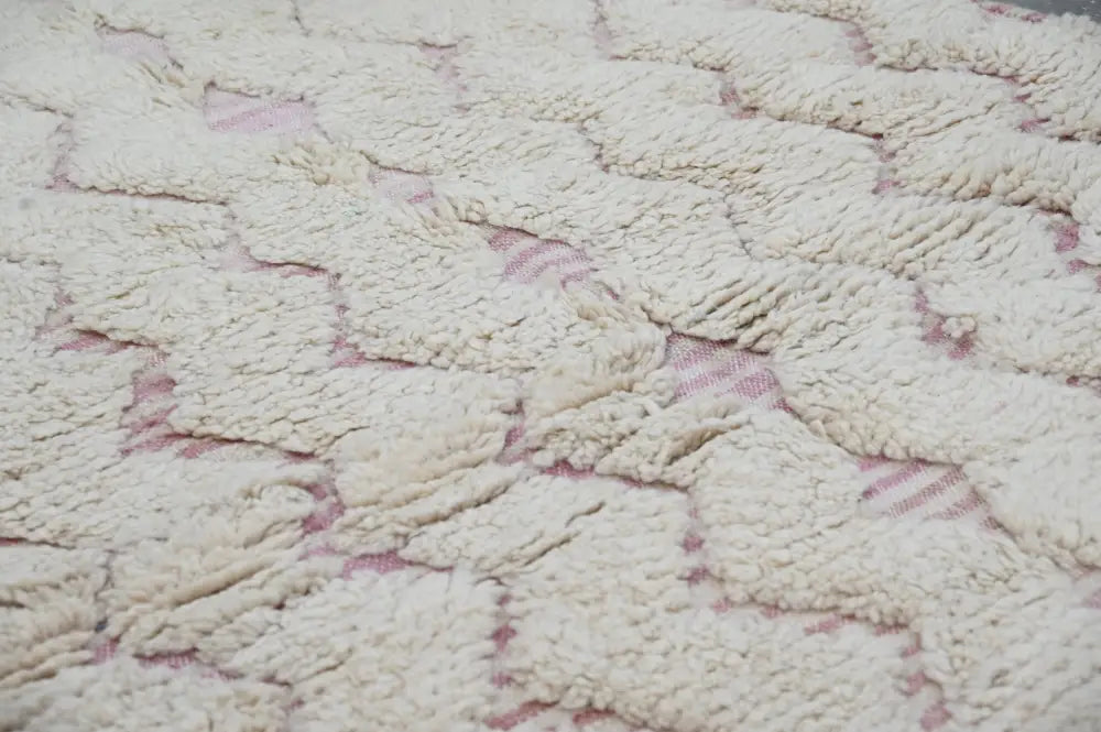 Cream-colored handmade traditional azilal rug with a plush texture and subtle pink geometric pattern 250x143cm