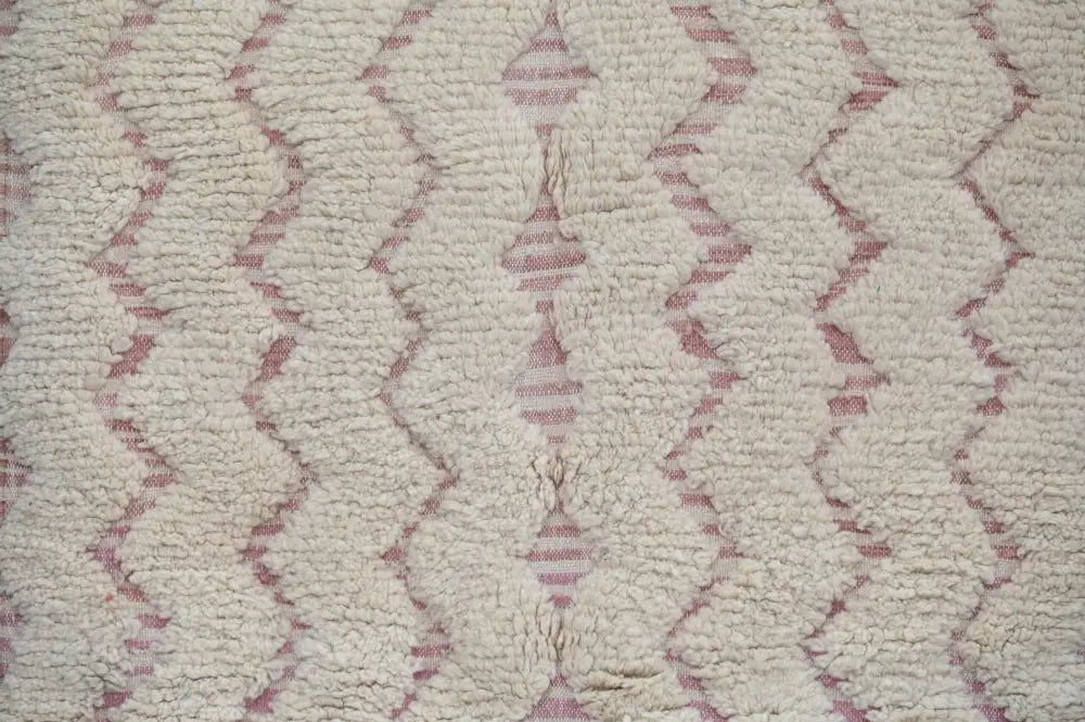 Cream-colored plush wool decorbites™ handmade traditional azilal rug with subtle muted pink geometric pattern 250x143cm