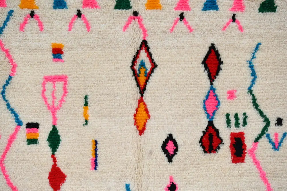 DecorBites™ handmade moroccan azilal rug with cream base and bold pink red blue geometric patterns 250x145 cm