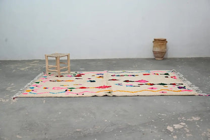DecorBites™ handmade moroccan azilal rug 250x145 cm with cream base and colorful geometric patterns in pink yellow blue green red