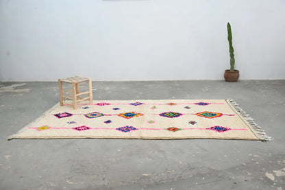 Beige handmade moroccan azilal rug with colorful geometric patterns and fringed edges, 250x148 cm by DecorBites